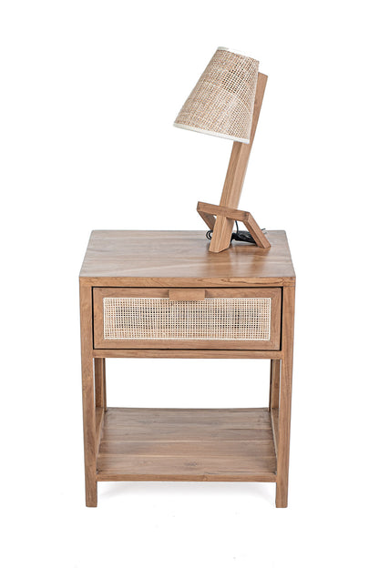 A rectangular side table made of teak wood with a rattan drawer and shelf, set against a white background.