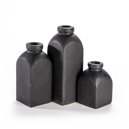 Three black ceramic vases of different sizes on a white background