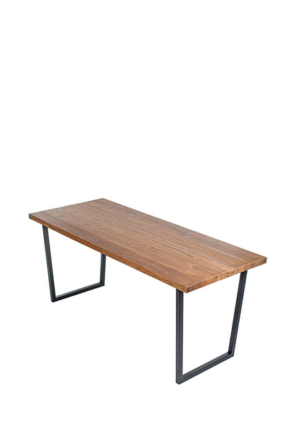 A rectangular dining table with a natural wood finish and black iron legs.