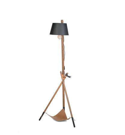 Floor lamp with black shade and wooden base on a white background