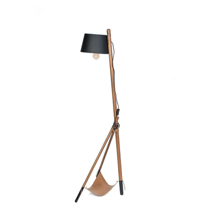 Floor lamp with wooden base and black shade on a white background