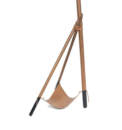 Brown leather swing with black ends on a white background