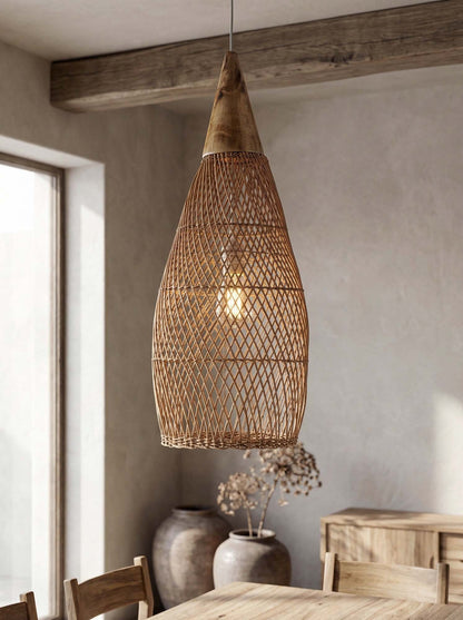 Woven rattan pendant light hanging in a room with wooden furniture and a window.
