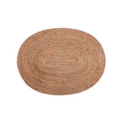 A natural color oval rattan table mat with intricate weaving techniques.