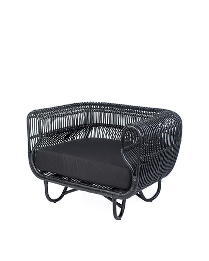 A black rattan solo sofa with a cushion on a white background, showcasing a woven design and a sleek modern look.