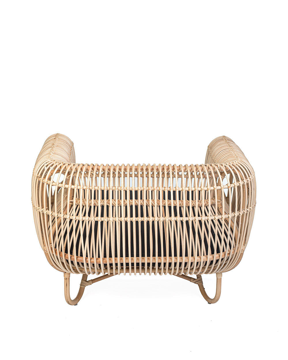 A natural color rattan sofa with black textile cushions.