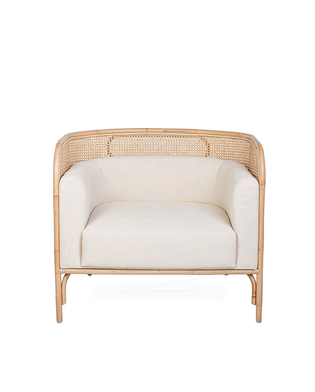 A white textile pillow on a rattan sofa with a natural color frame.