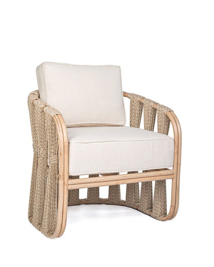 A beige Rattan Solo Sofa with a woven rope design and white textile pillows.