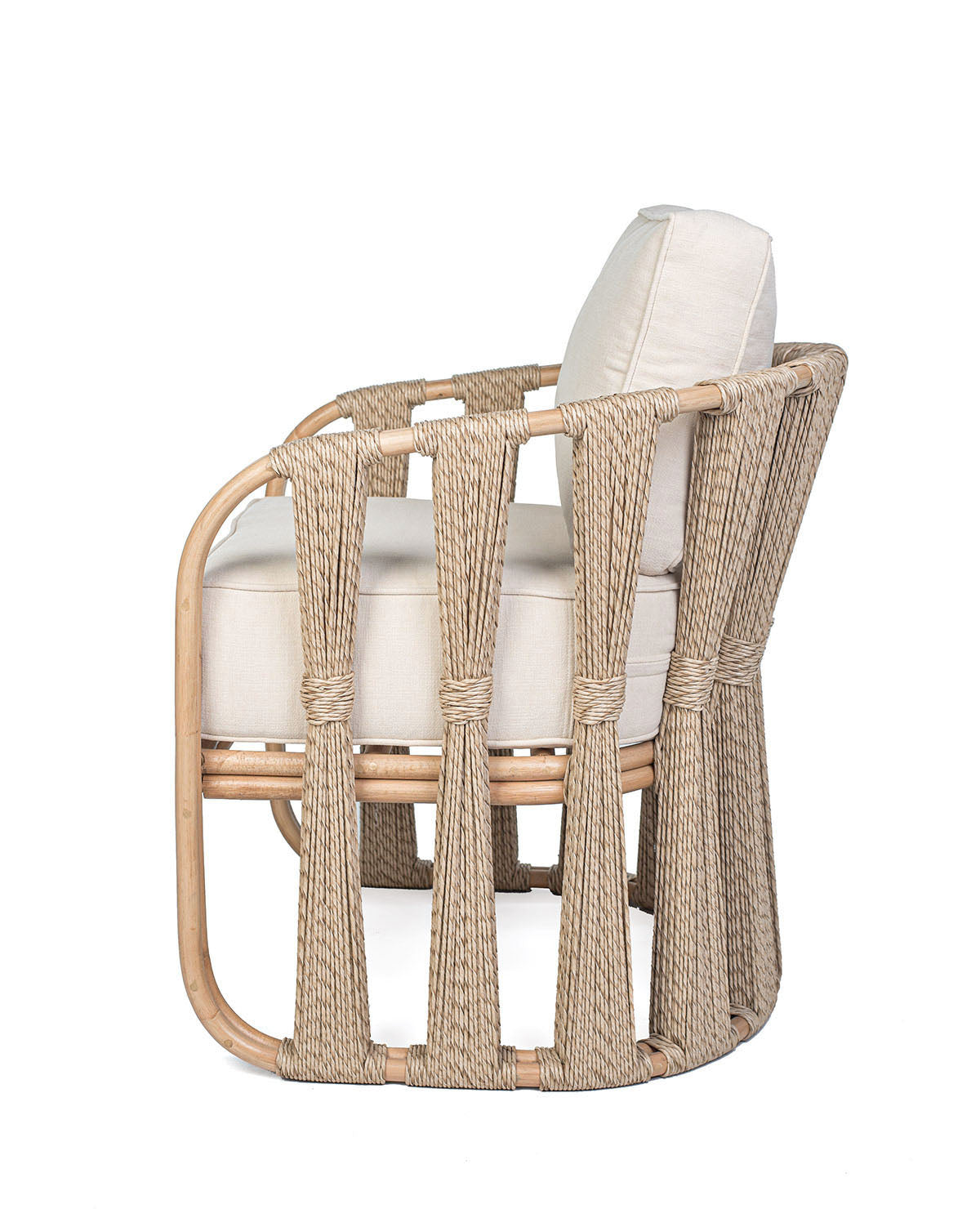 A beige Rattan Solo Sofa with a woven rope design and white textile pillows.