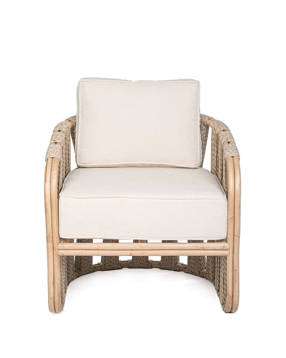 A beige Rattan Solo Sofa with a woven rope design and white textile pillows.
