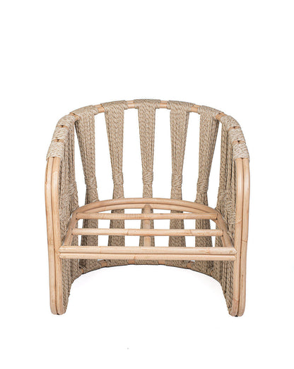 A beige Rattan Solo Sofa with a woven rope design and white textile pillows.