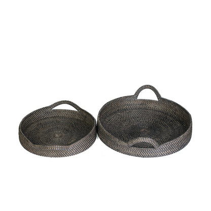 Two round rattan trays, one larger than the other, with a patterned weave design in black color.