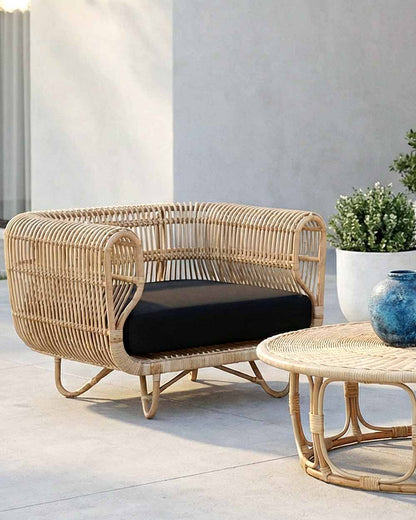 Wicker outdoor furniture set with a cushion on a patio