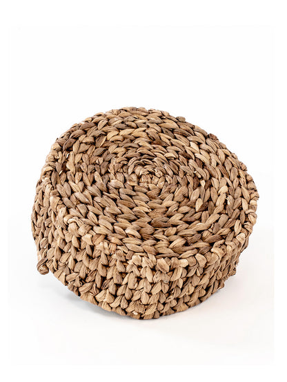 A hand woven natural water hyacinth basket with a open circular shape, featuring a richly textured and colored natural material, suitable for storing everyday items.