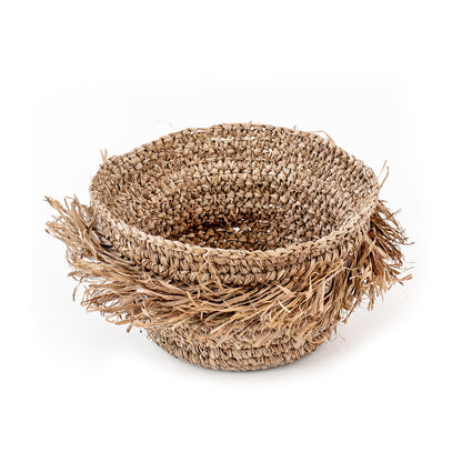 A round, natural color woven basket made of seagrass, with a rustic and natural appearance.