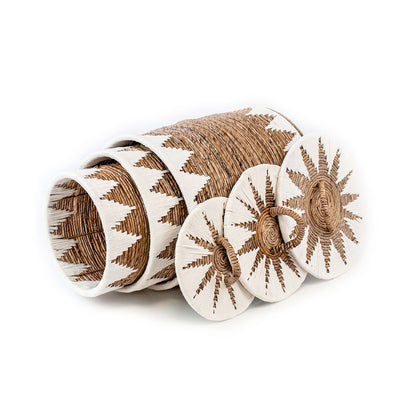 A set of wicker baskets with natural sea grass and banana leaves, featuring a traditional technique and a touch of macrame cotton.