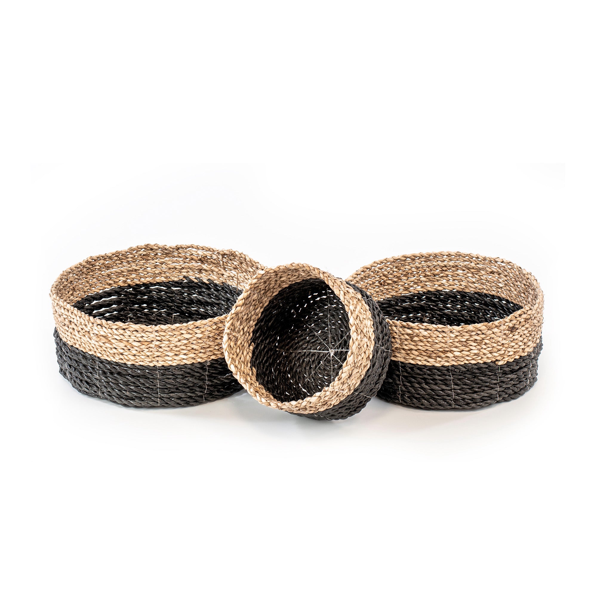 A set of three natural rattan woven baskets in three different sizes, in natural and black color.