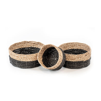A set of three natural rattan woven baskets in three different sizes, in natural and black color.