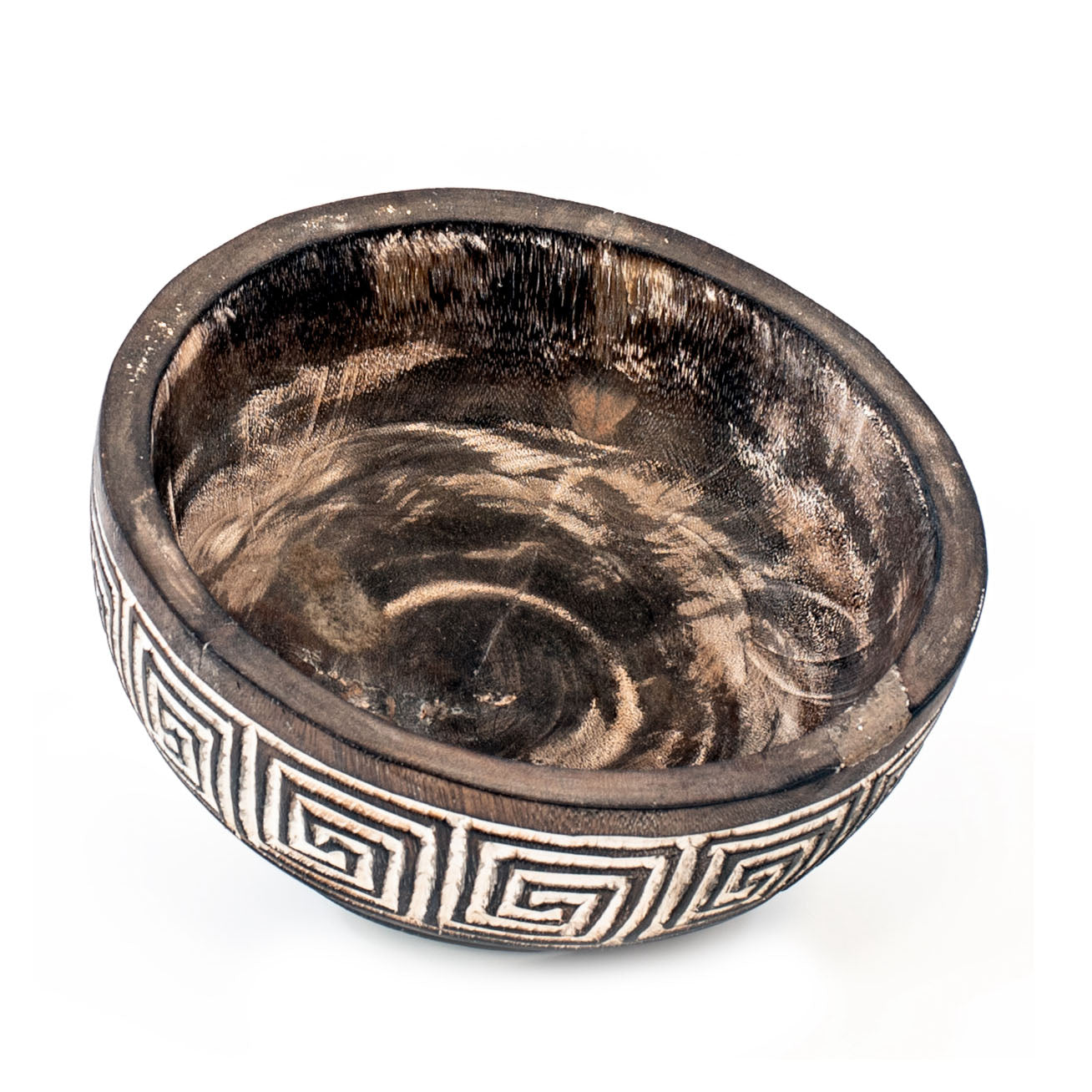 A hand-carved wooden bowl with geometric patterns, primarily in brown color with white accents.