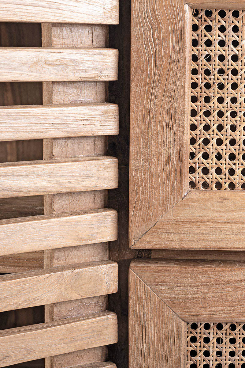 Detail of wooden TV cabinet with rattan drawers, featuring a natural color and an ethnic design.