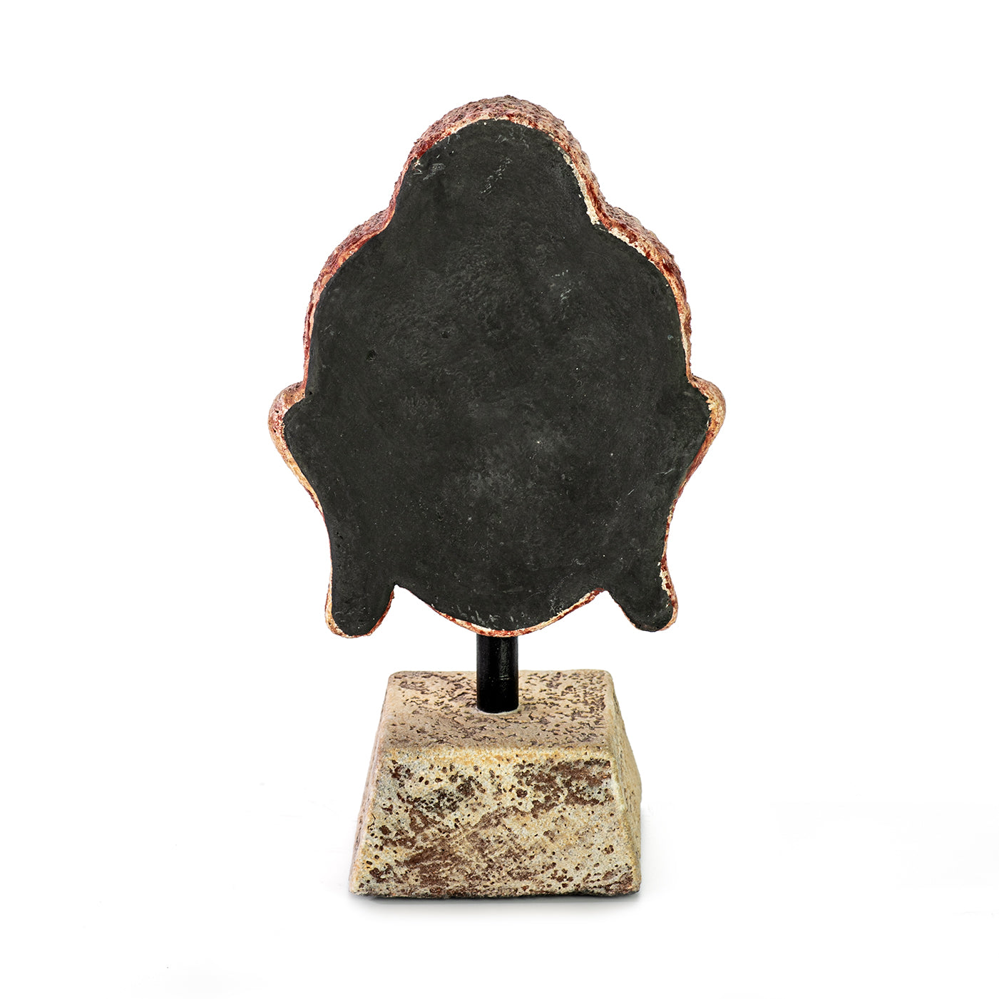 Handmade ceramic Buddha head sculpture on a pedestal, in ocher color,, backside view.