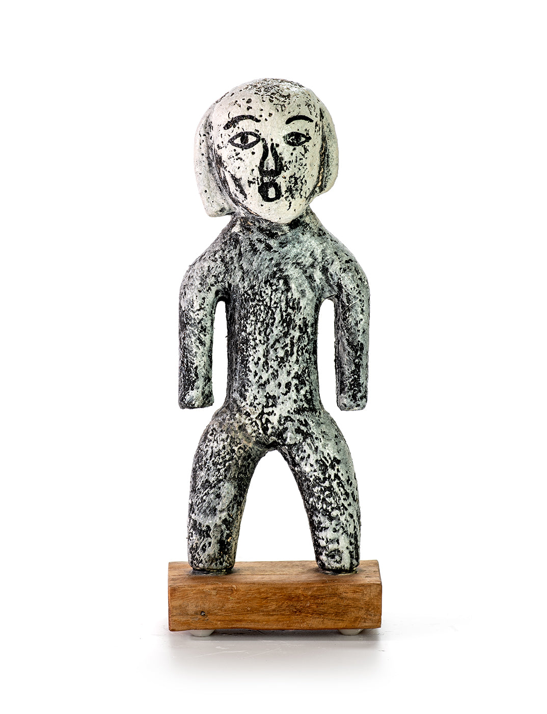 Handmade ceramic miniature figure of a person with a finish resembling ancient stone artifacts, displayed on a wooden stand.