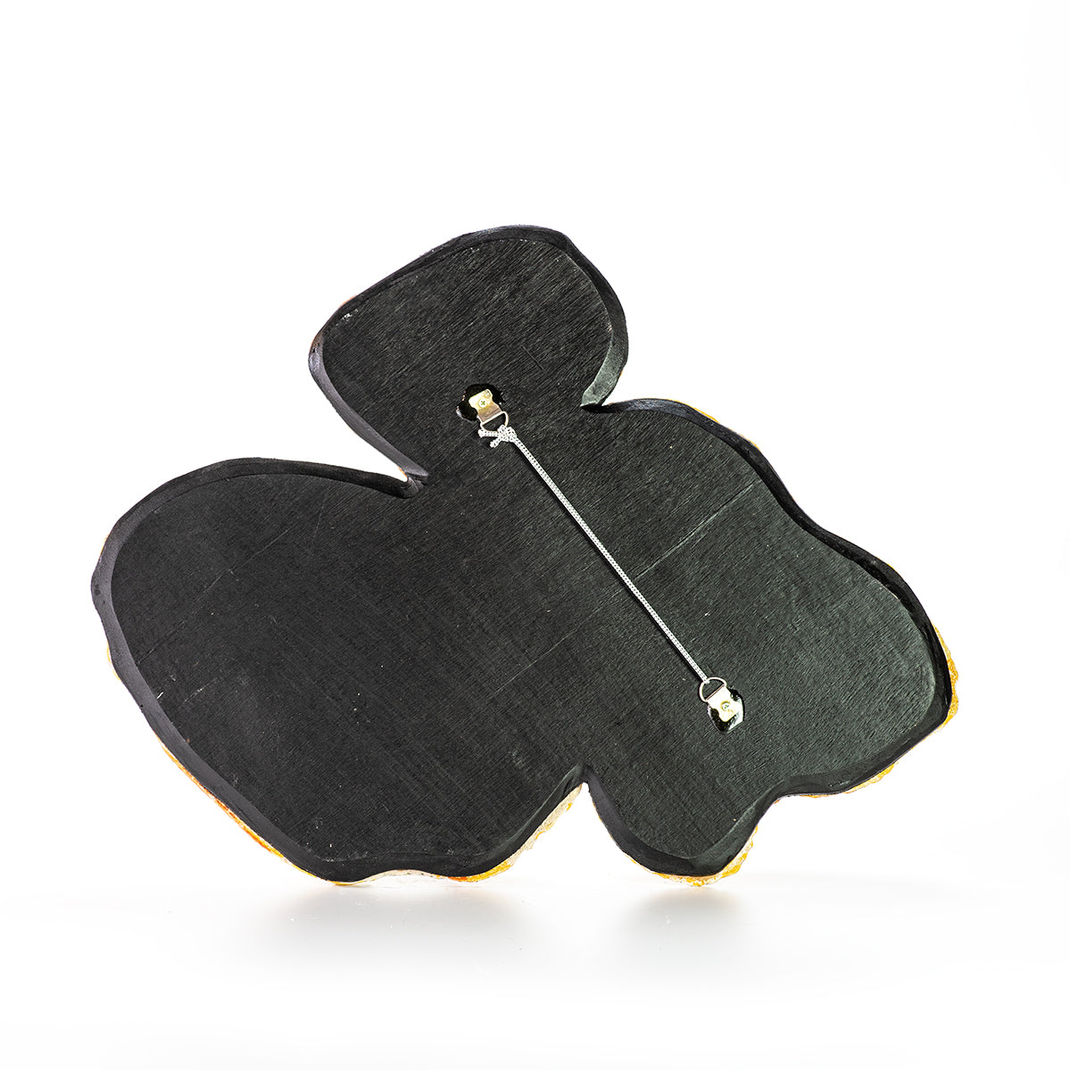 Hand painted ceramic coral elements in pastel yellow tones, with a textured surface, backside view.