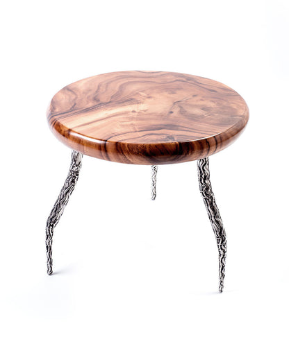 A round teak wood coffee table with a glossy finish and metal support legs with a relief structure. Top view. 