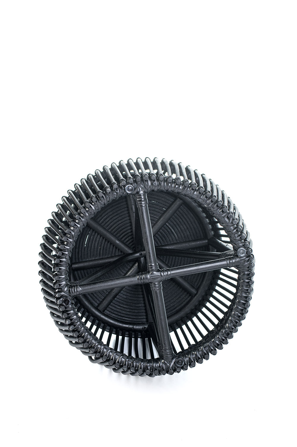 A round black coffee table made of natural rattan, with a geometric pattern, placed against a white background.