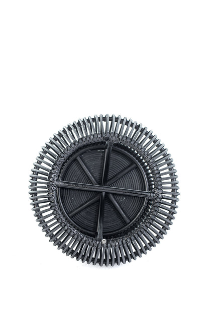 A round black coffee table made of natural rattan, with a geometric pattern, placed against a white background.