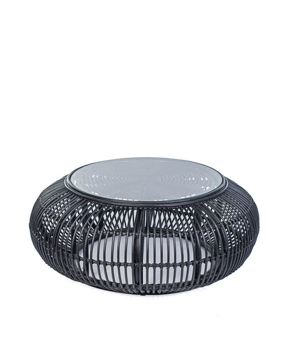 A black rattan coffee table with a glass top, suitable for indoors or outdoors use.