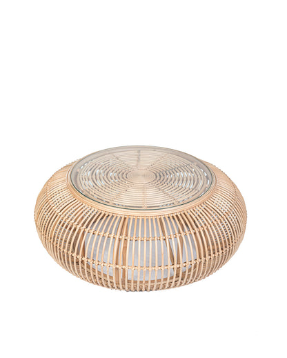 A natural color rattan coffee table with a glass top, suitable for indoors or outdoors use.
