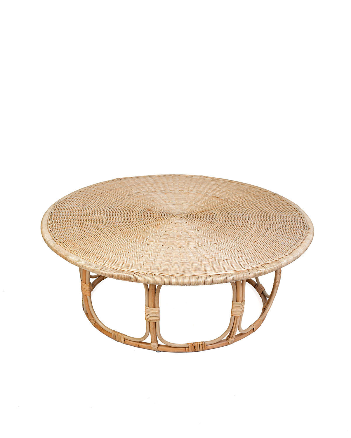 A natural color rattan coffee table with a round shape and visible weave pattern, with no visible legs.
