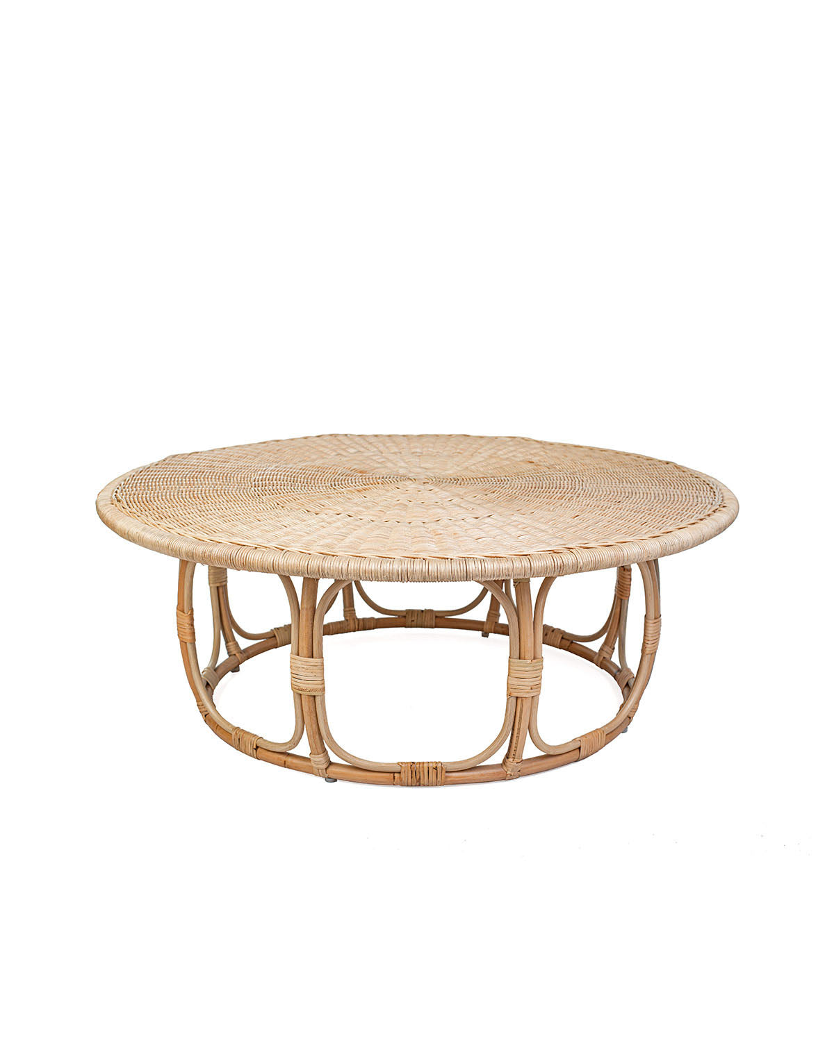 A natural color rattan coffee table with a round shape and visible weave pattern, with no visible legs.