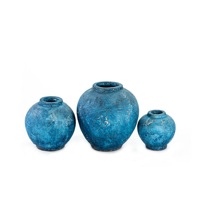 Three blue ceramic decorative vases with a rustic finish, three different sizes. 
