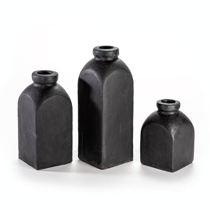 Three black ceramic vases of different sizes on a white background