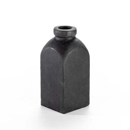 A tall, black ceramic decorative vase with a narrow neck and a rounded base.