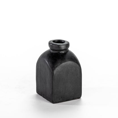 A tall, black ceramic decorative vase with a narrow neck and a rounded base.