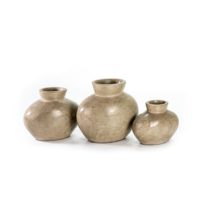 Three beige ceramic decorative vases with a smooth, textured surface, three different sizes. 