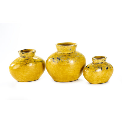 Three yellow ceramic decorative vases with a rounded shape, in three different sizes.