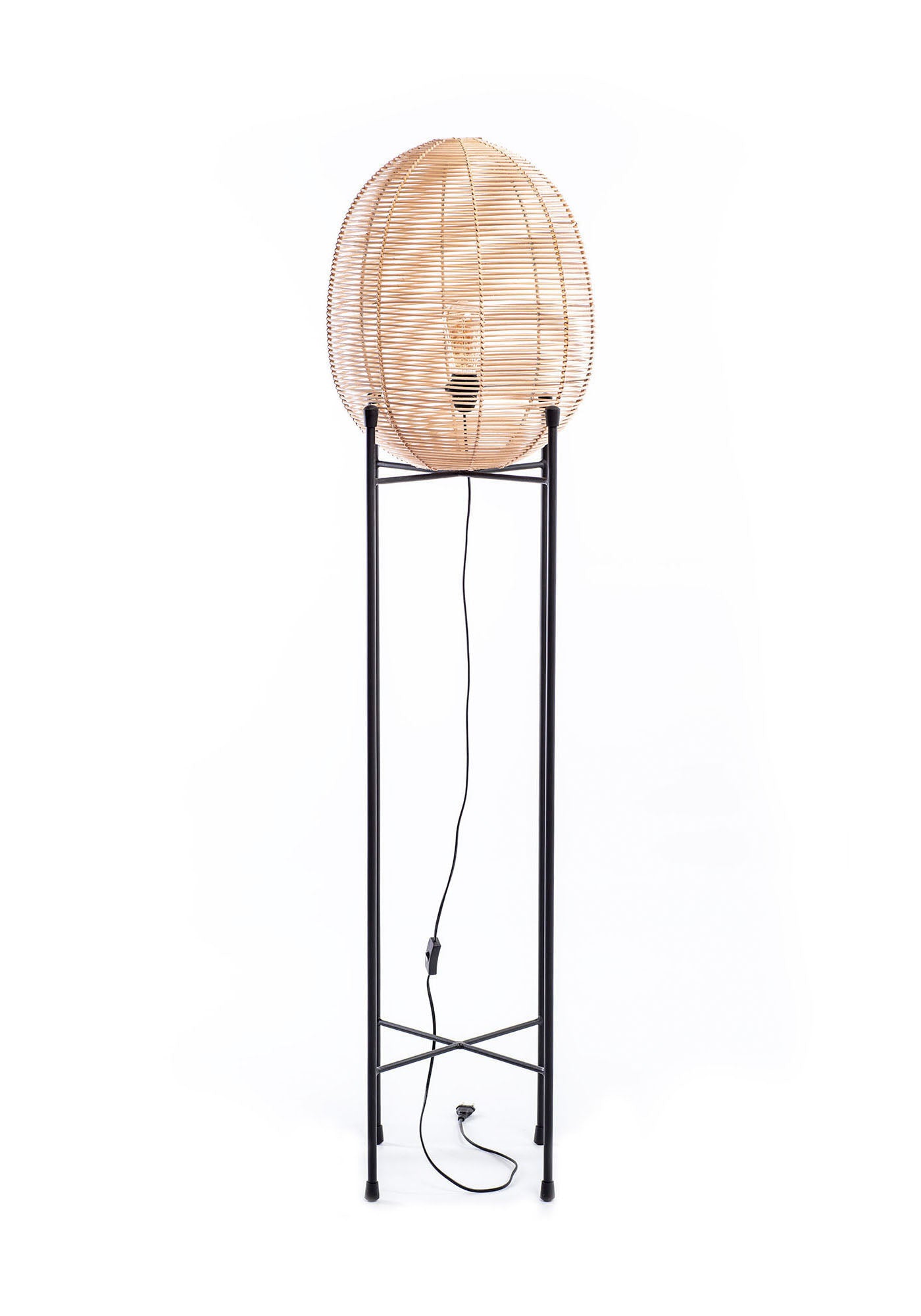 A tall floor lamp with a black metal frame and natural rattan shade, standing against a white background.