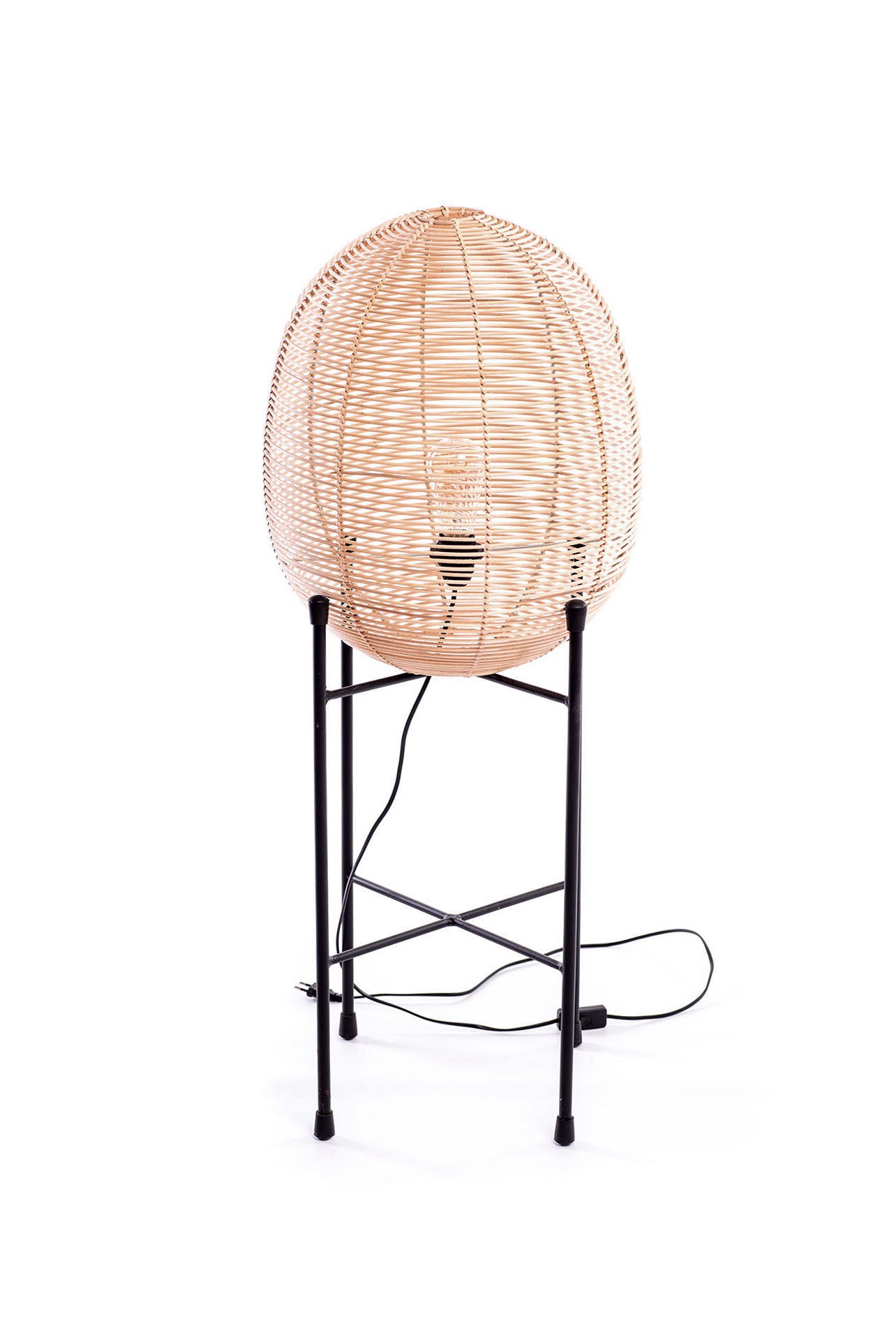 A tool floor lamp with a black metal frame and rattan shade.