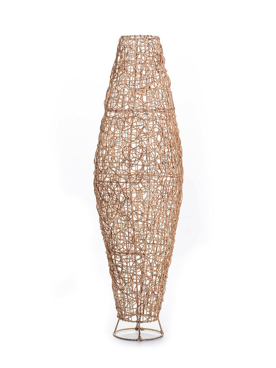 A tall natural color rattan floor lamp with a tapered design, complete with a base and a cable, against a white background.