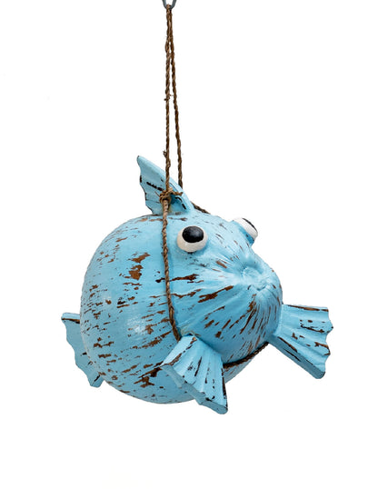 A hand-painted blue fish-shaped decoration made from coconut shell, suspended by a string.