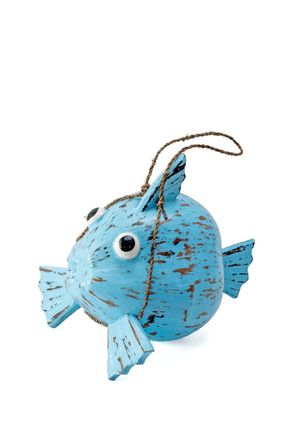 A hand-painted blue fish-shaped decoration made from coconut shell, suspended by a string.
