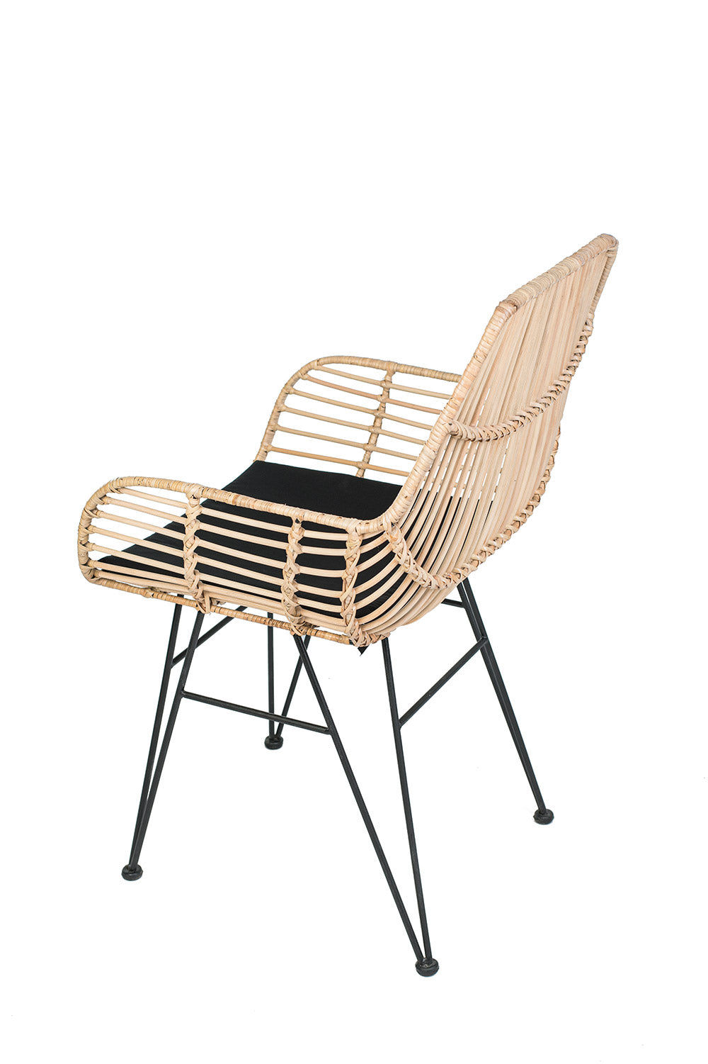A lounge chair with a black iron frame, natural color woven rattan and black  seat cushion.