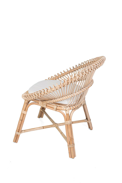 Wicker chair with a white cushion on a black background