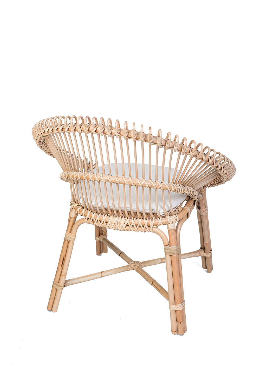 Wicker chair with a white cushion on a black background