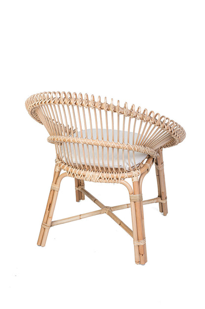 Wicker chair with a white cushion on a black background