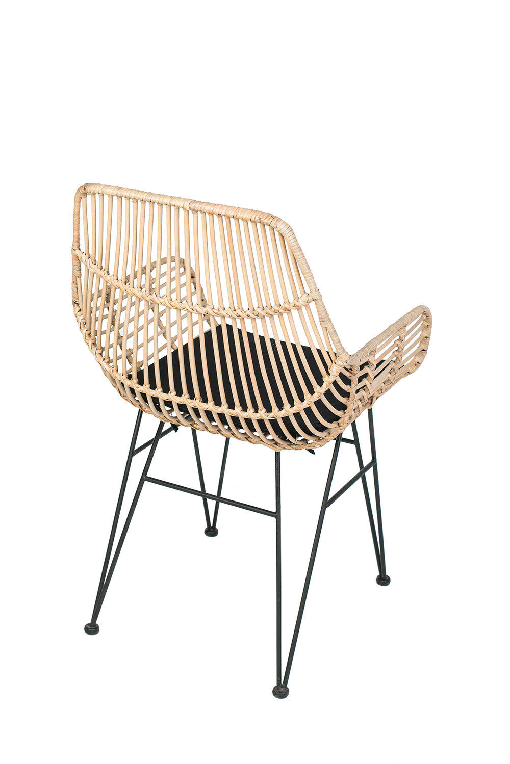 A lounge chair with a black iron frame, natural color woven rattan and black  seat cushion.